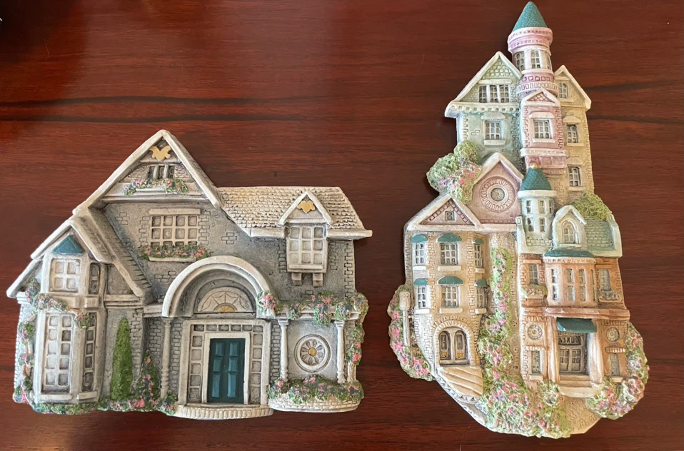 Two decorative wall-hanging house plaques