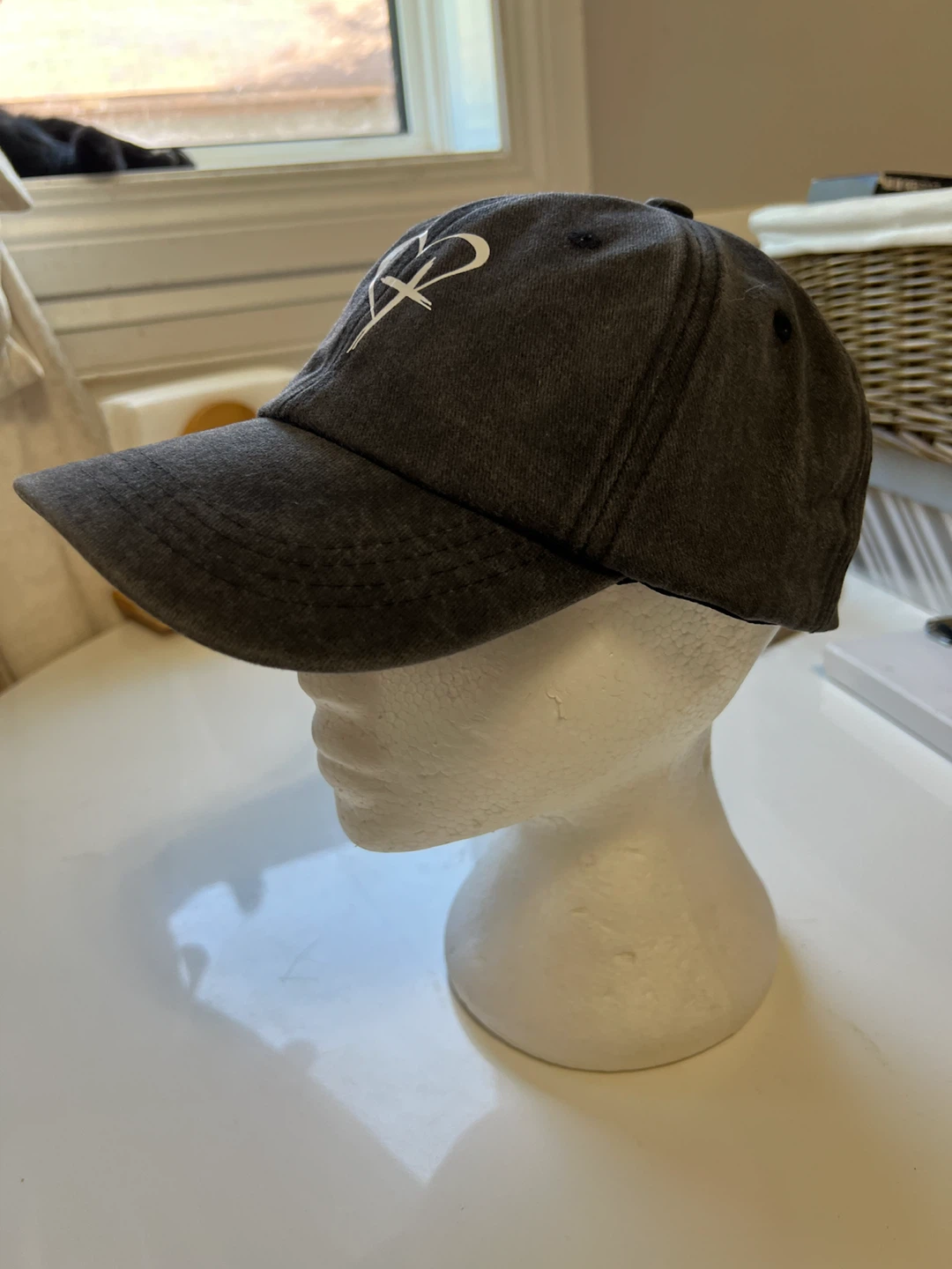 Dark grey baseball cap with heart and cross logo