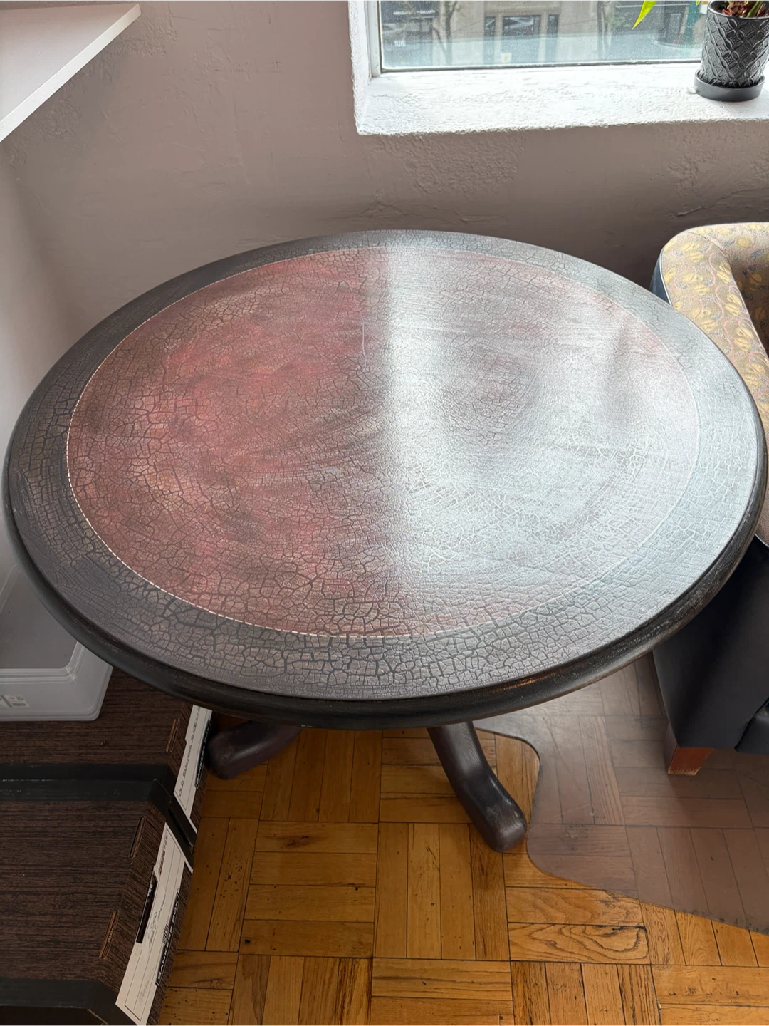 Round wooden pedestal table with crackle finish