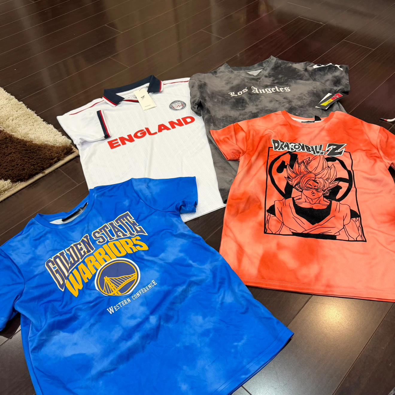 Four assorted graphic and sports t-shirts 8/11 years
