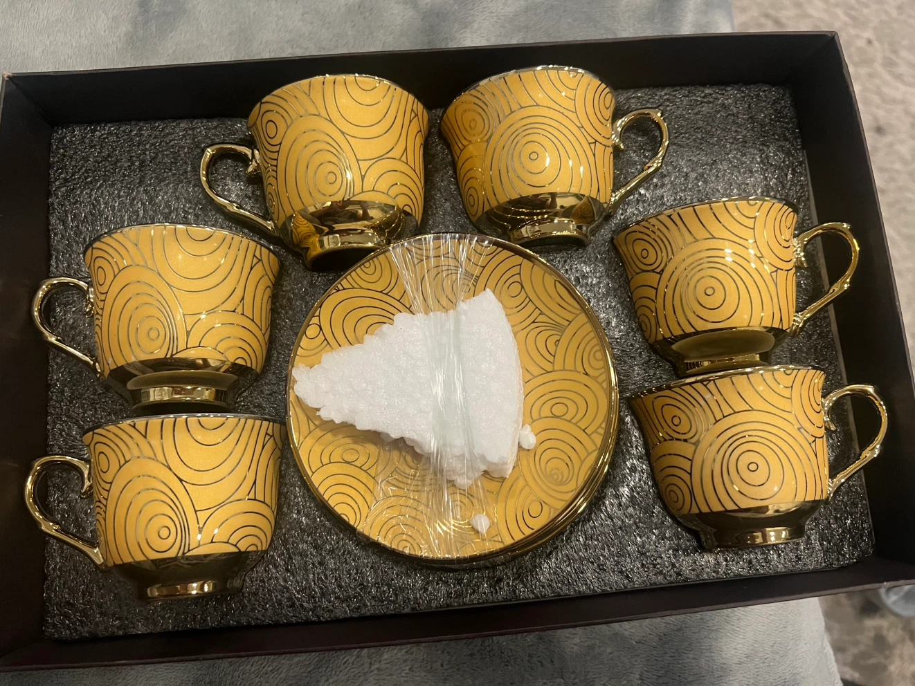 Gold patterned tea cup and saucer set mini