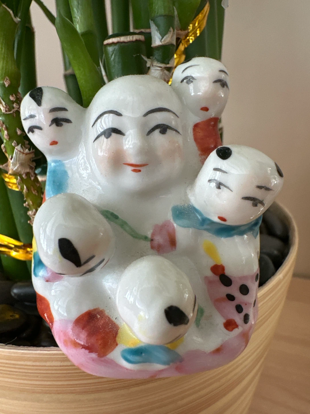 Ceramic Laughing Buddha figurine with children
