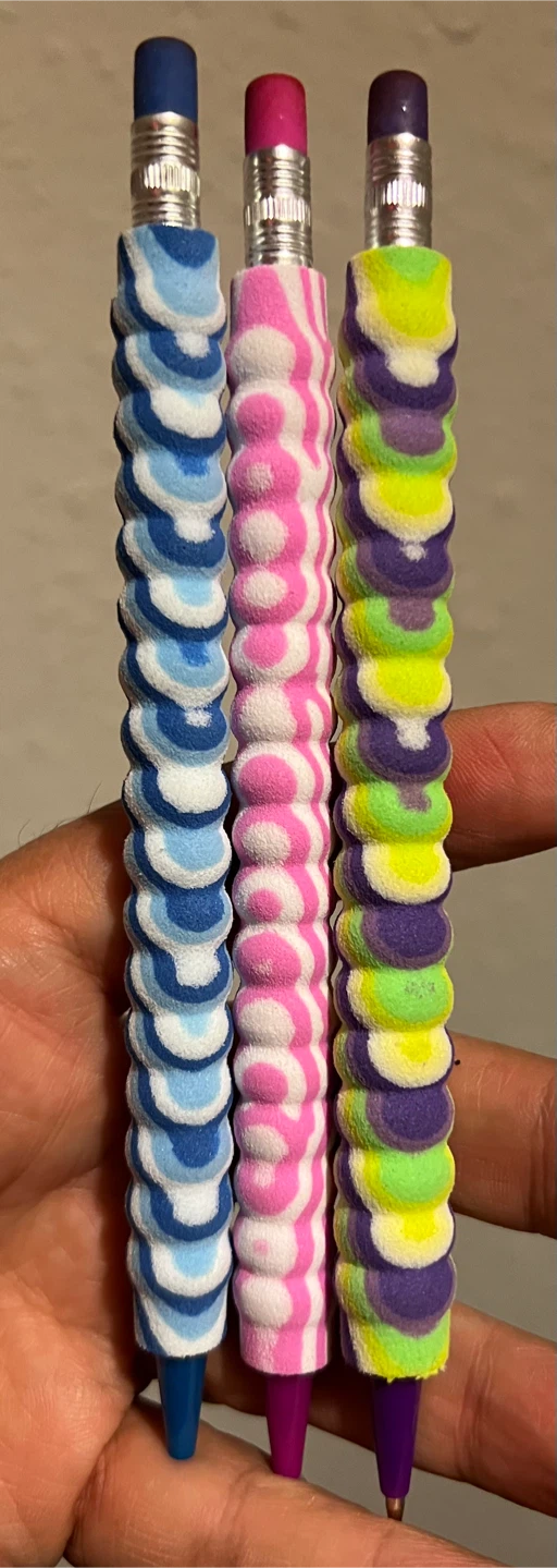 Three colourful patterned pens