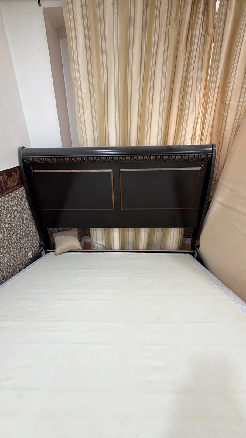A queen size bed with Black Sleigh Bed frame