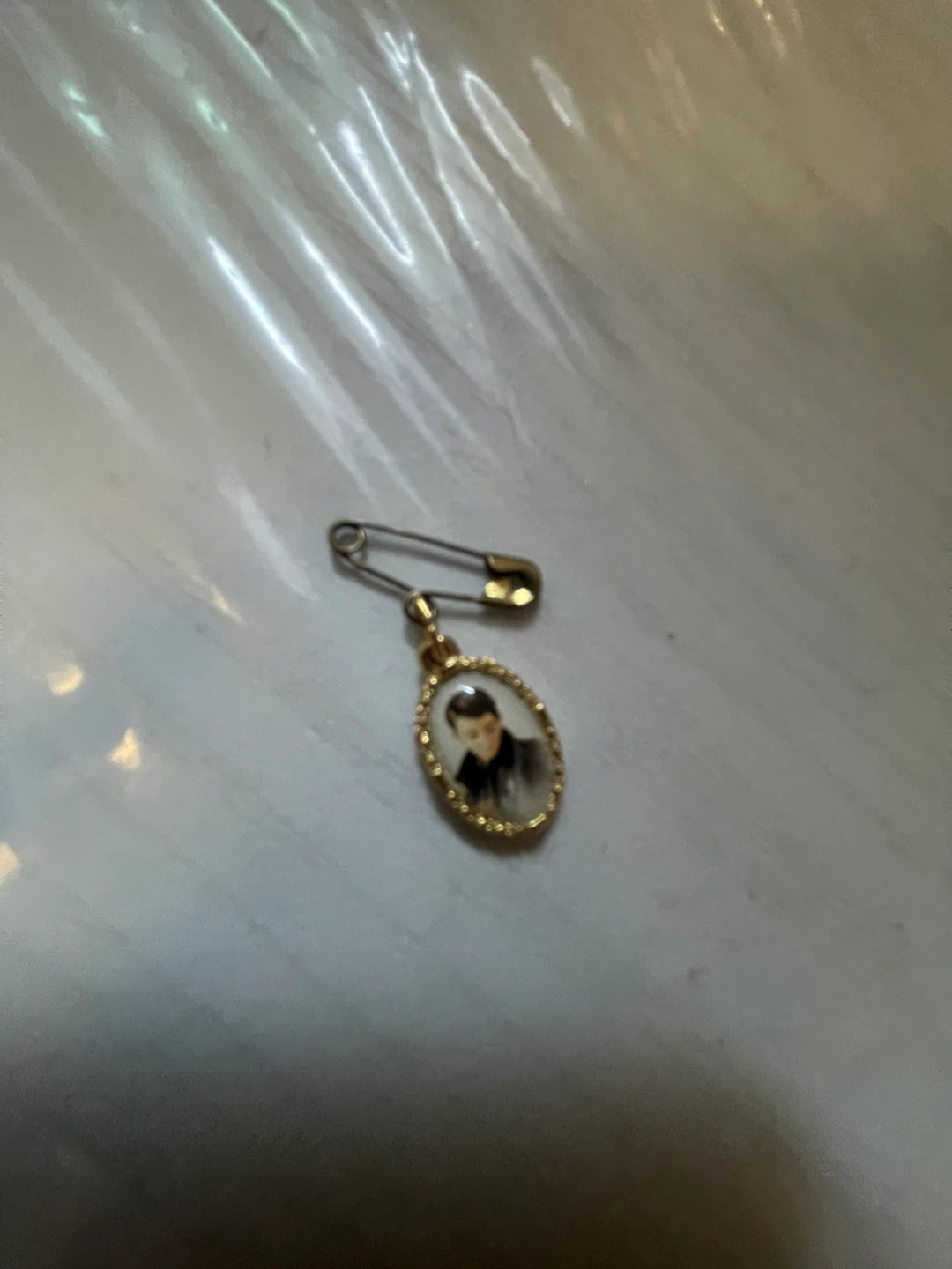 Gold-tone religious pin