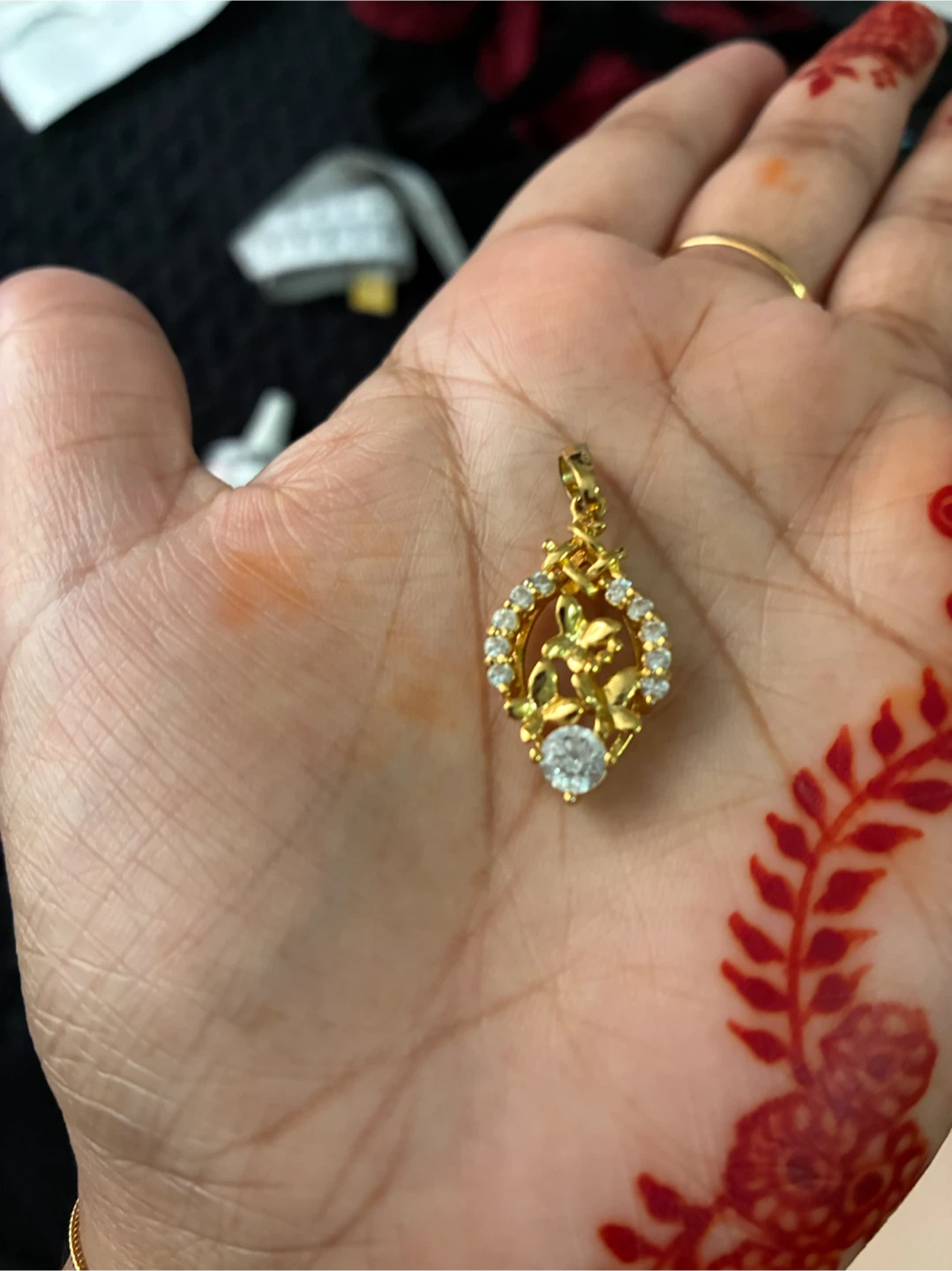 Gold-tone floral pendant with crystals