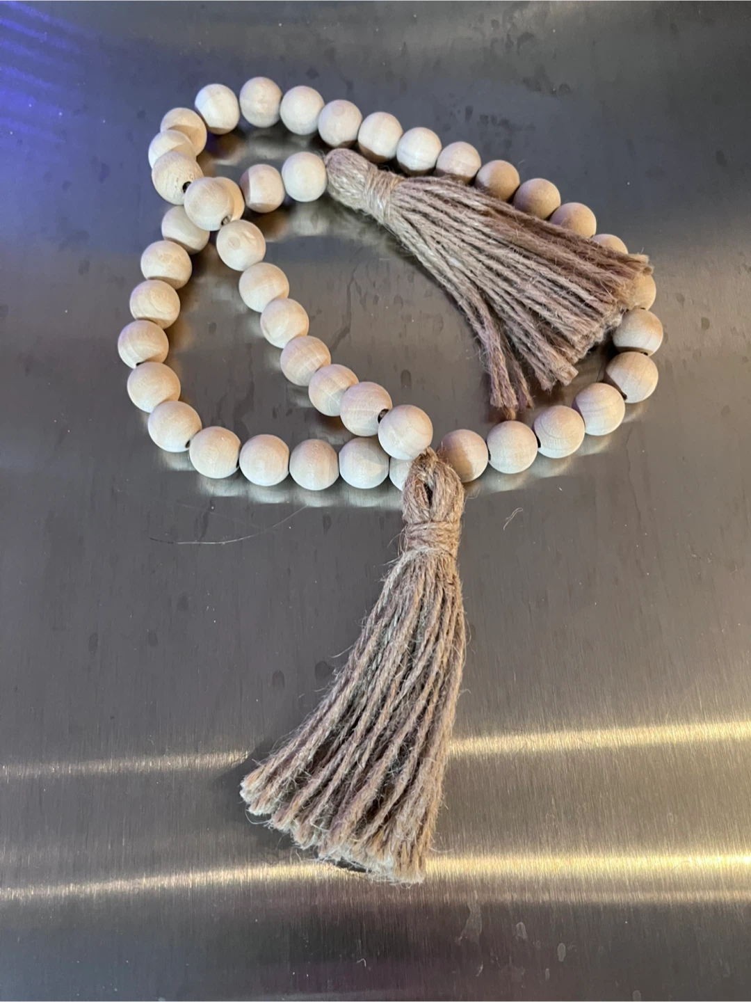 Decorative wooden bead garland with jute tassels