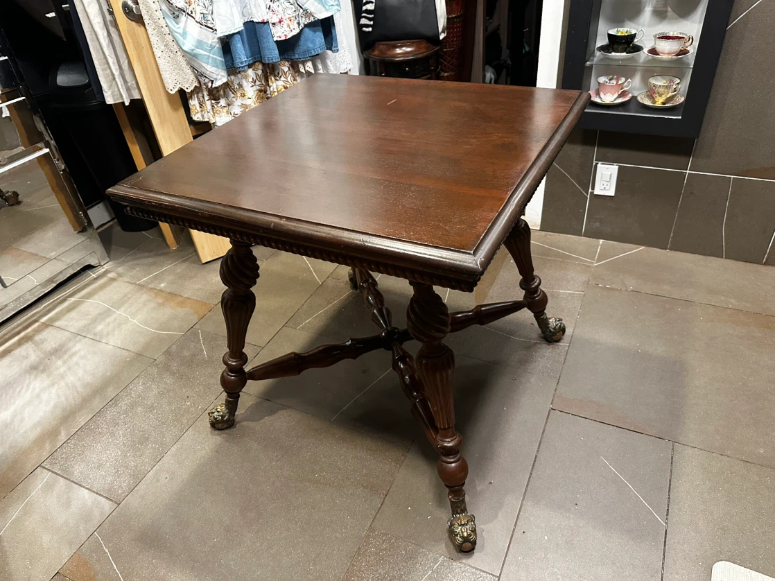 Elegant antique carved table with ornate metal legs