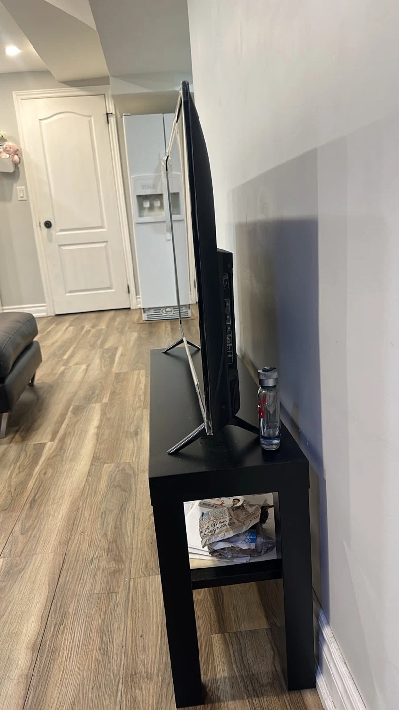 TCL Television with table - photo 2
