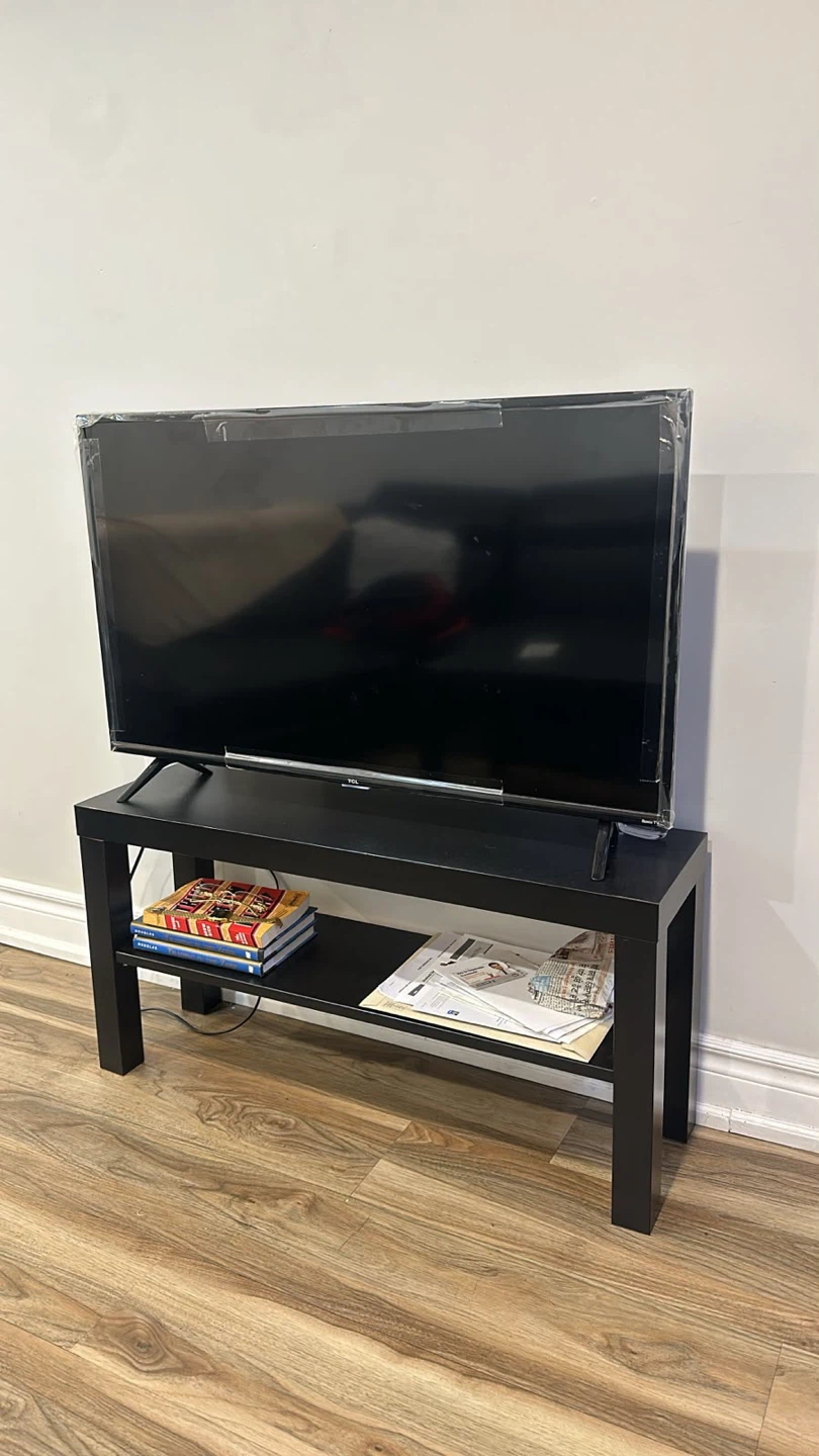 TCL Television with table - photo 3