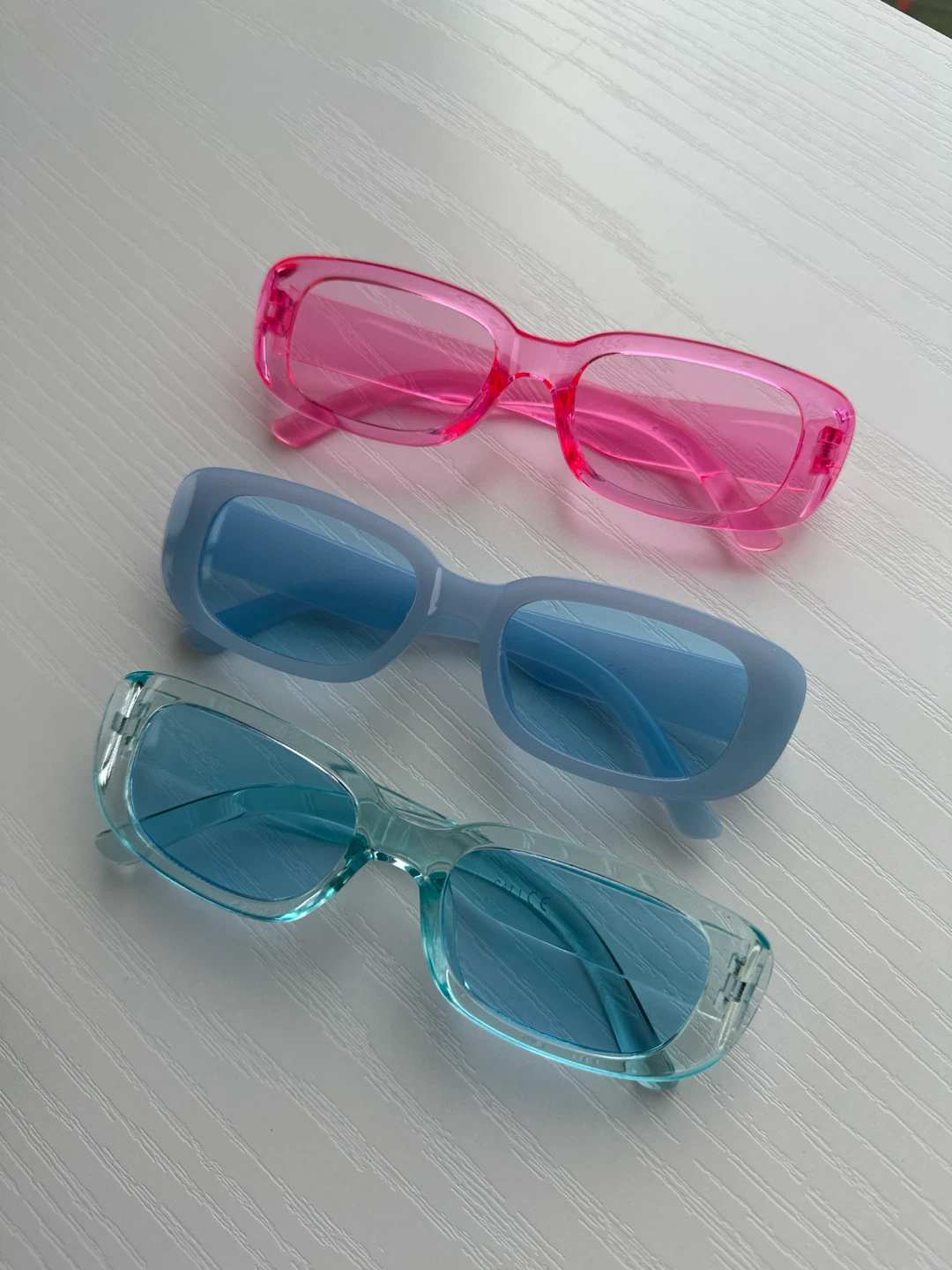 Three pairs of colourful rectangular sunglasses