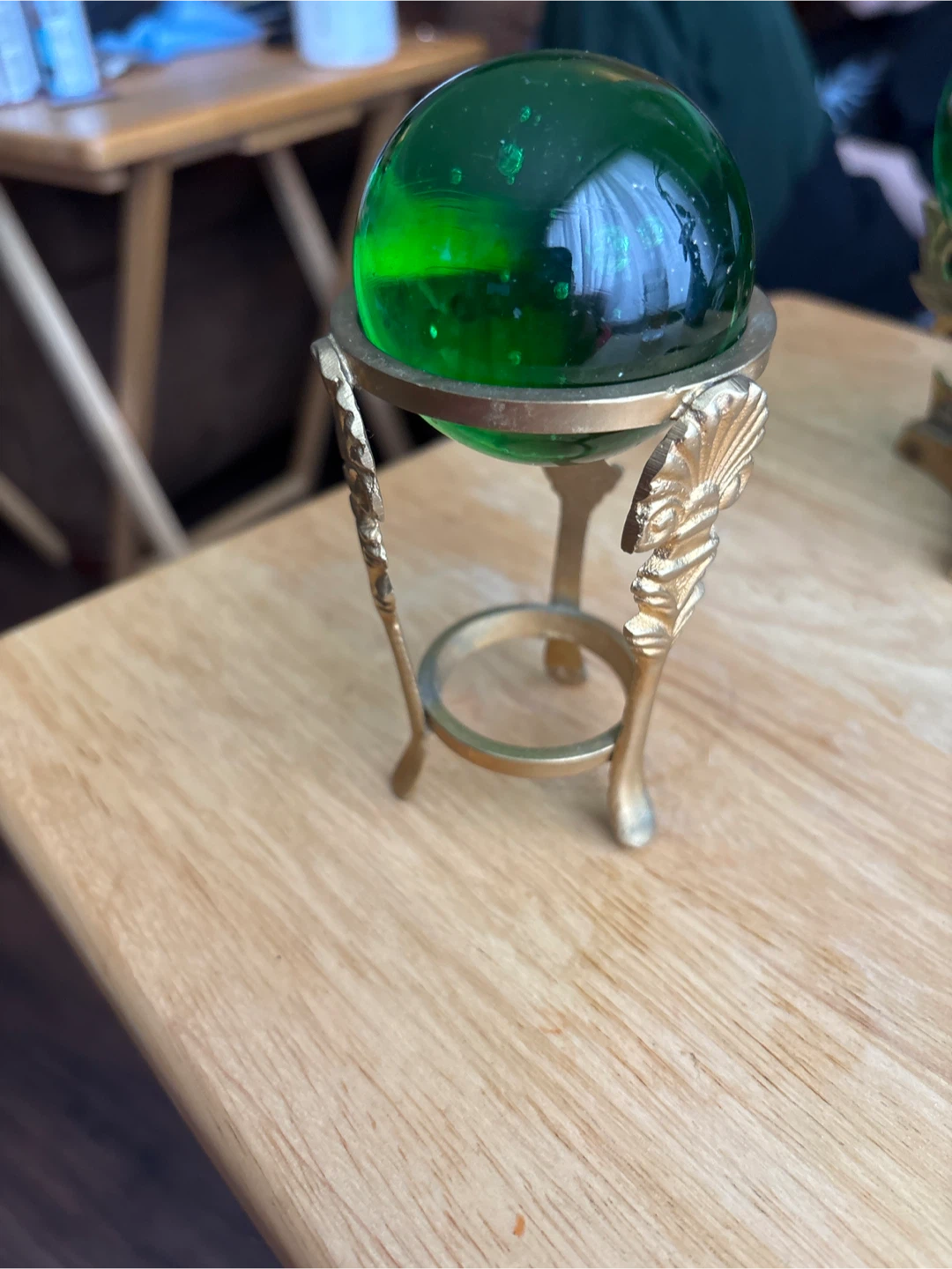 Green Glass Sphere on Ornate Brass Stand