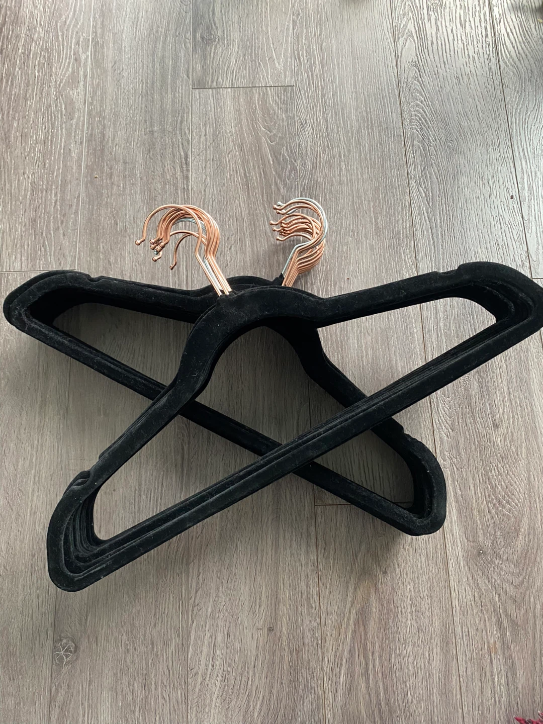 Set of black velvet hangers with rose gold hooks