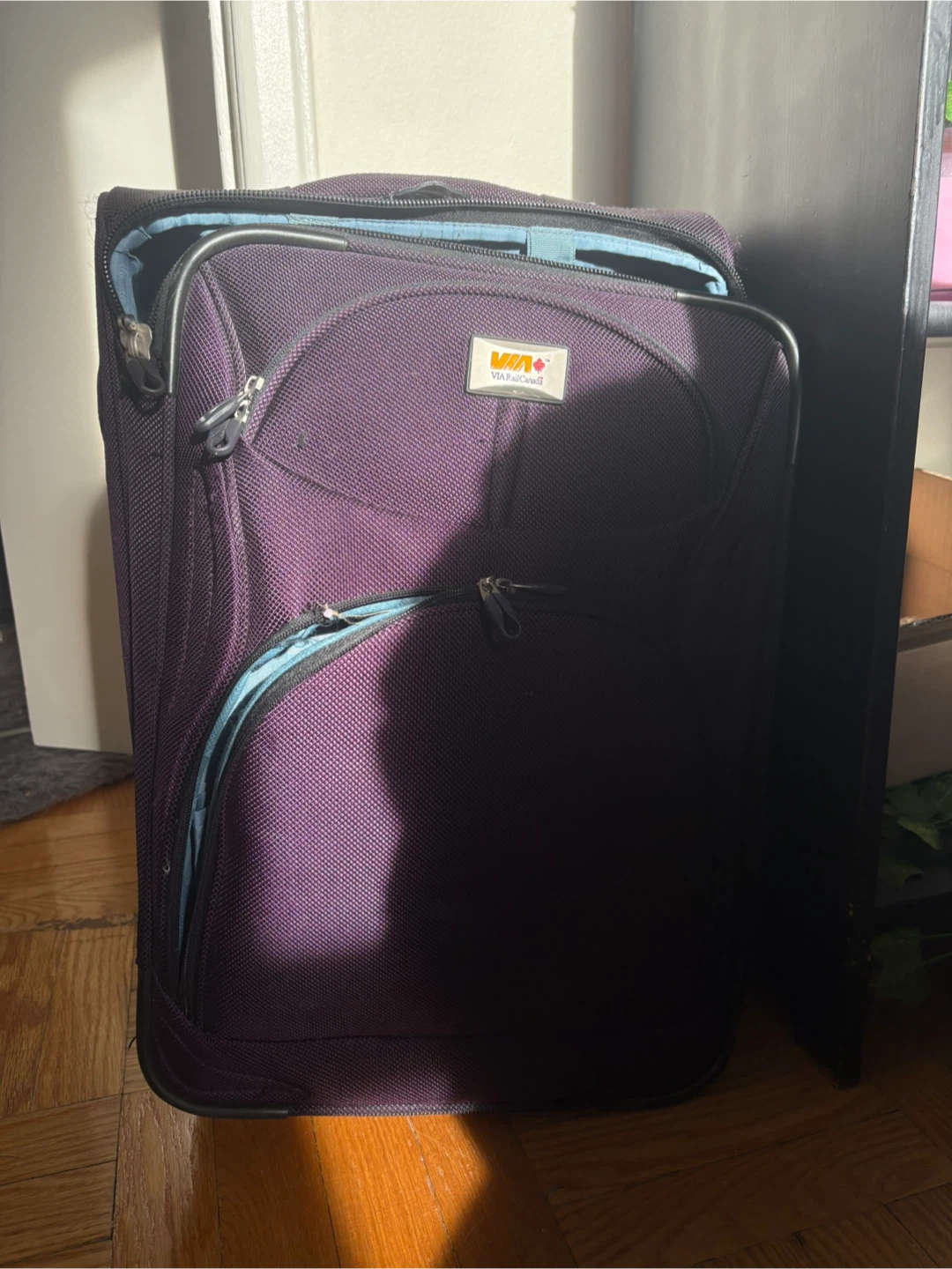 VIA Rail Canada purple rolling suitcase