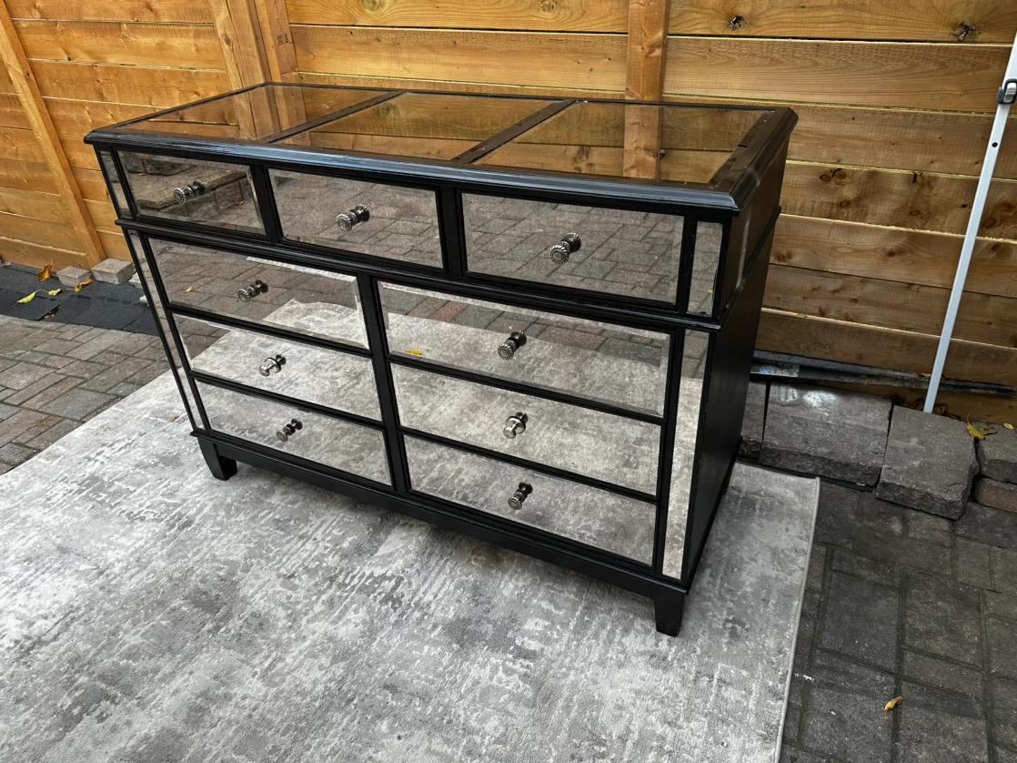 Sleek black‑framed mirrored dresser with luxurious look