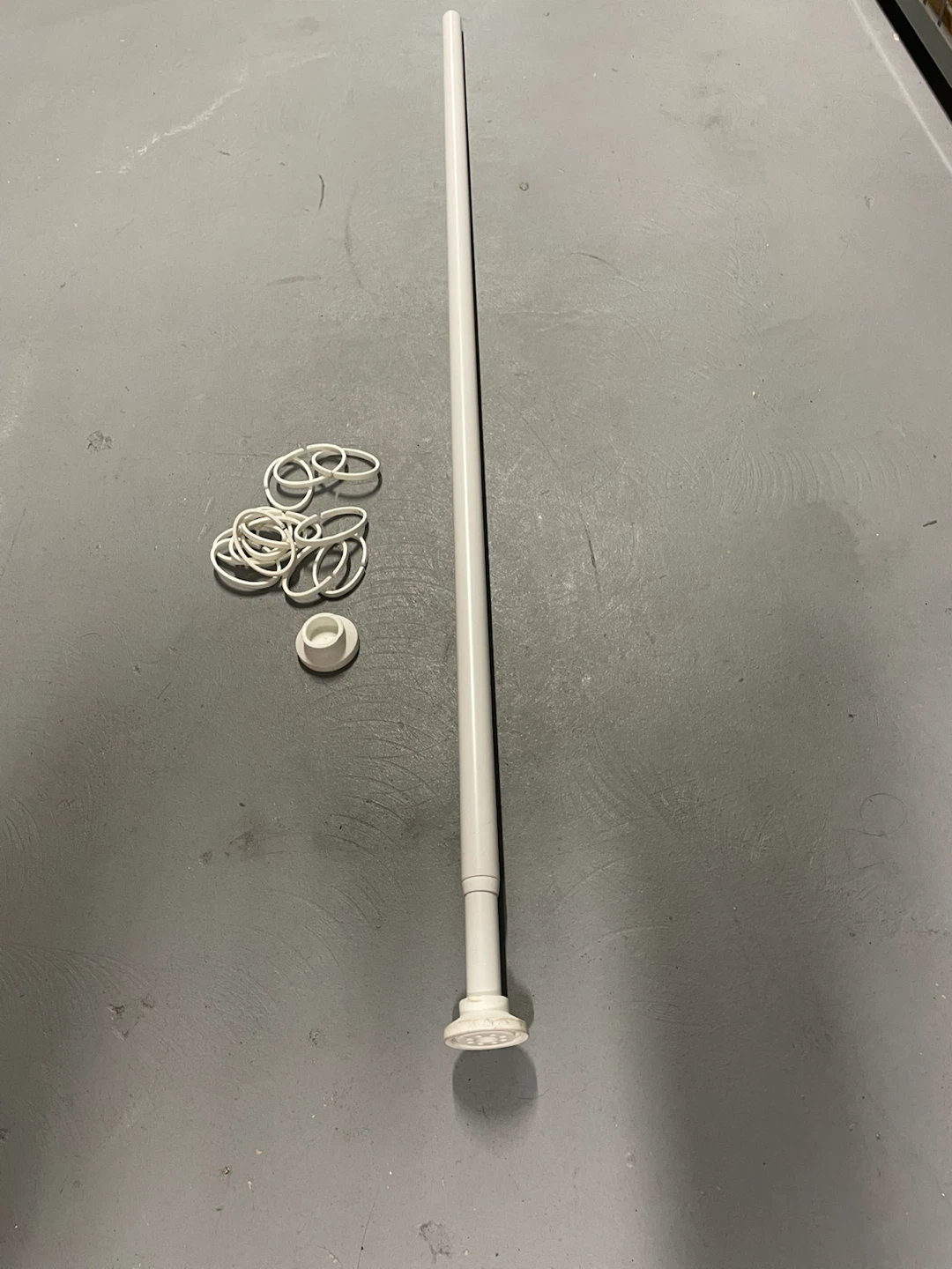 White tension shower curtain rod with rings