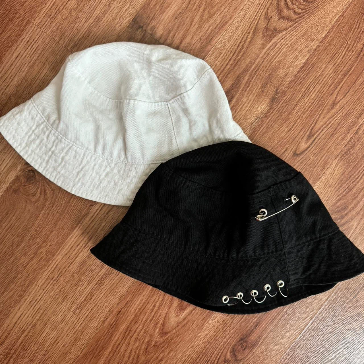 Two cotton bucket hats in black and white
