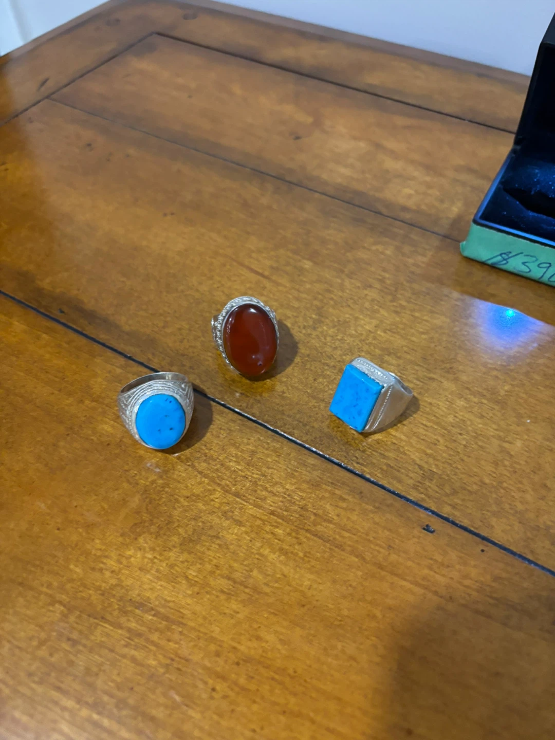 Three gemstone rings in individual boxes
