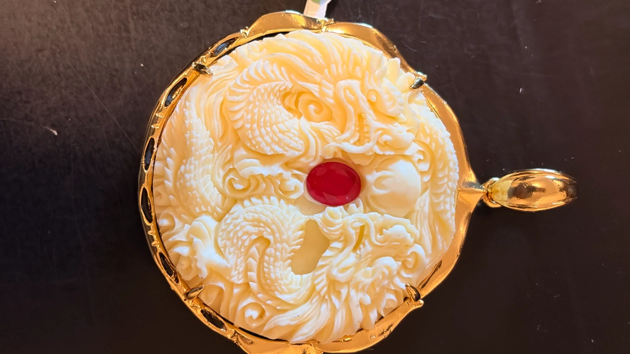 Gold dragon pendant with red stone