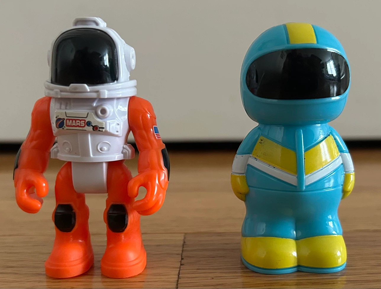 Two astronaut toy figures