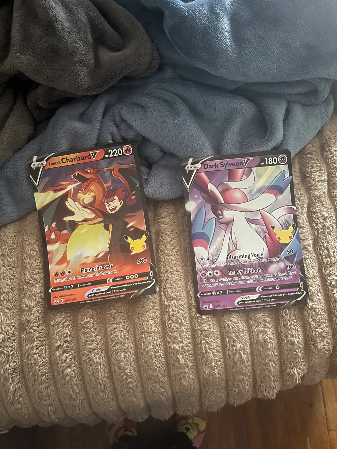 Lance's Charizard V and Dark Sylveon V Pokemon Cards