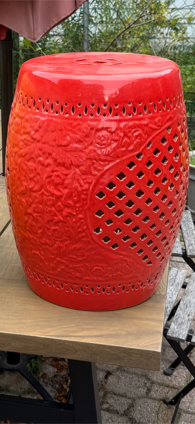 Red ceramic garden stool with a lattice pattern