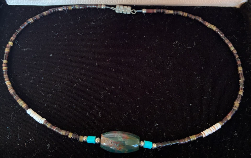 Beaded necklace with central stone