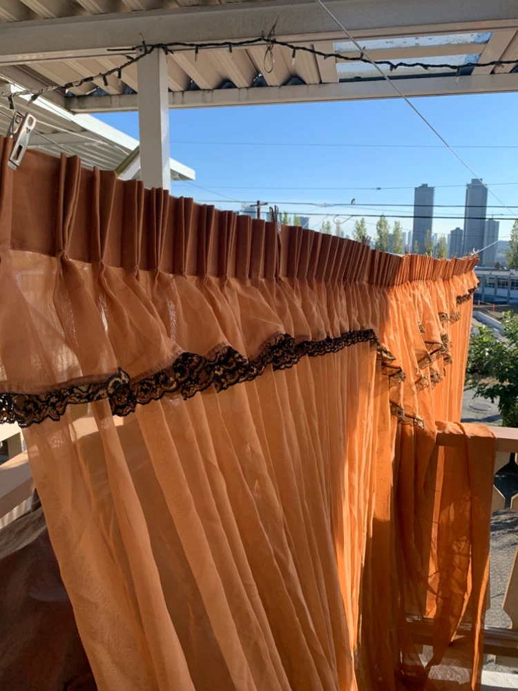 Orange sheer curtains with lace trim