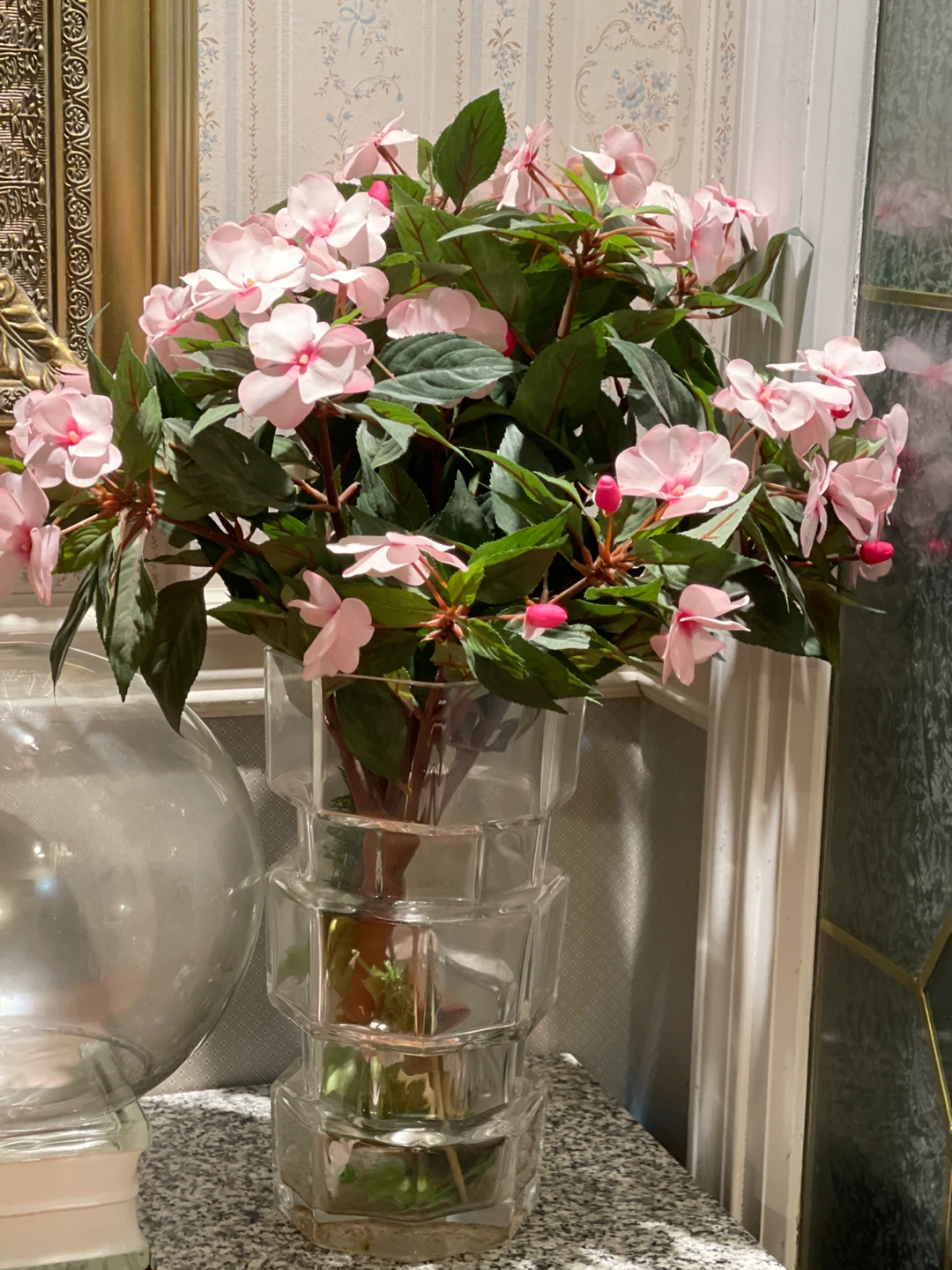 Clear glass geometric vase with artificial flowers