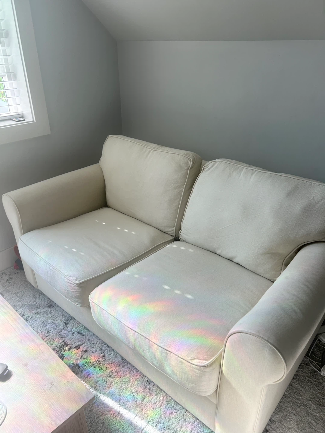 Cream coloured two-seater sofa