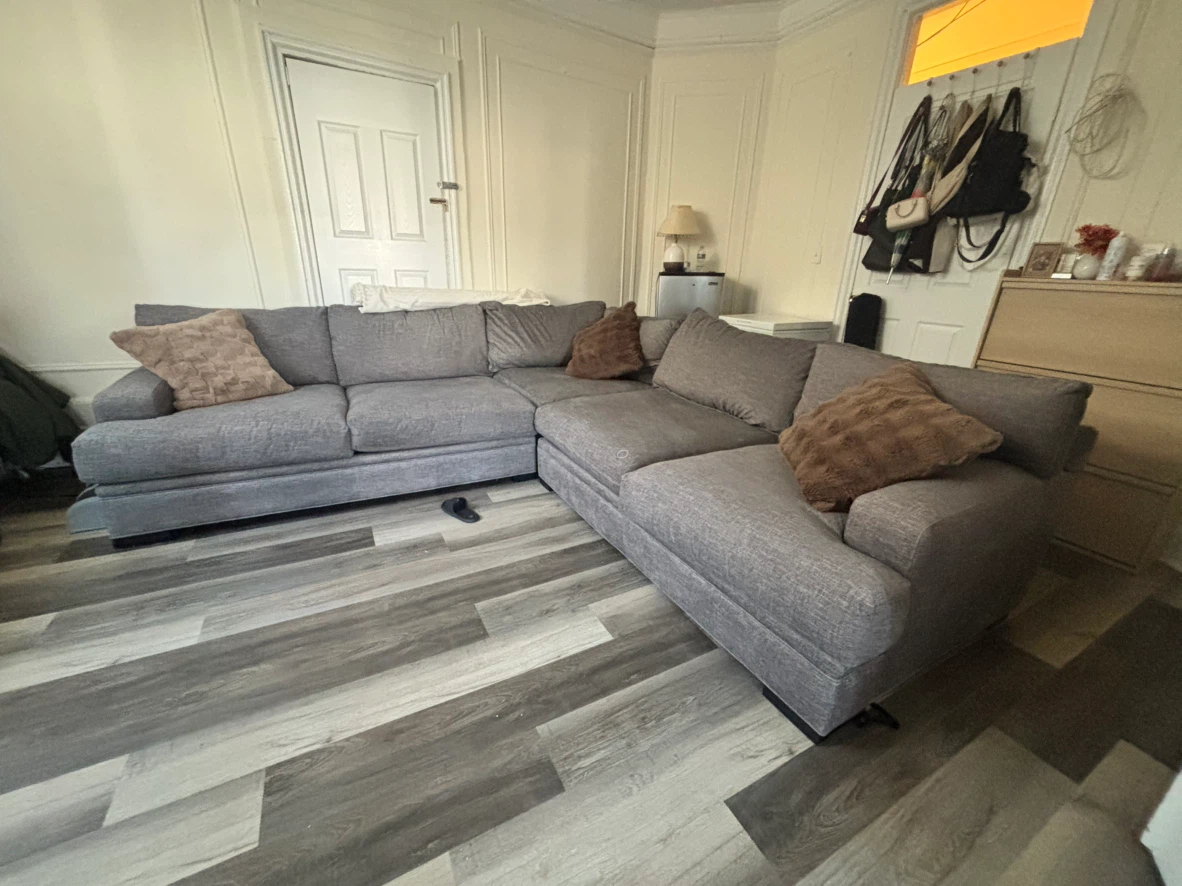 Grey fabric L - shaped sectional couch