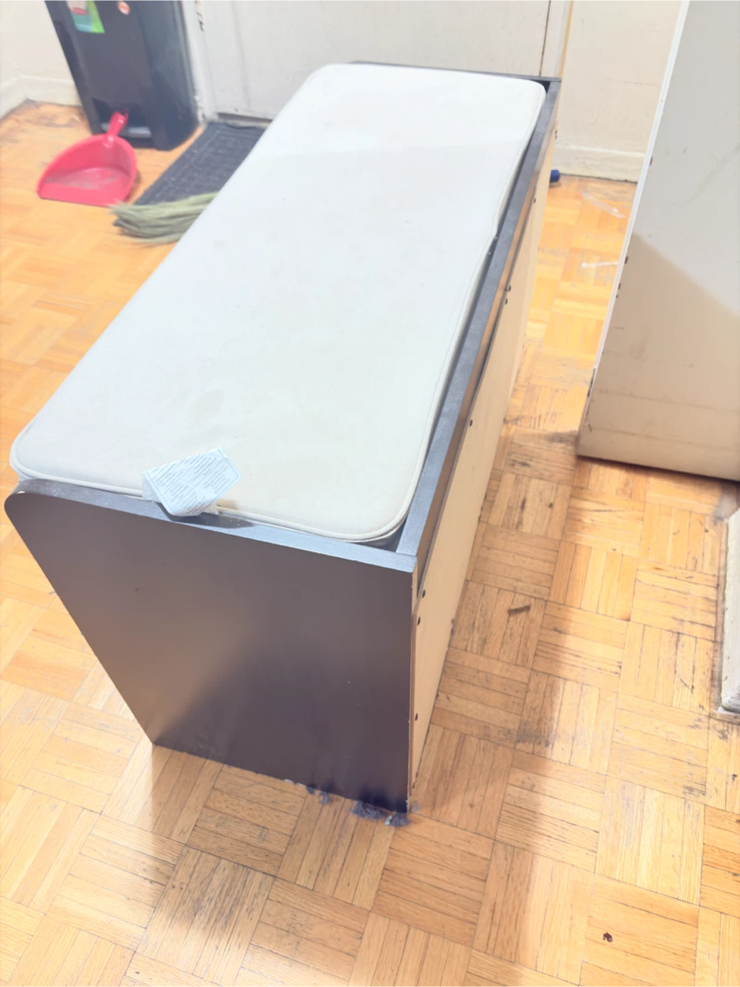 Black shoe storage bench with white cushion