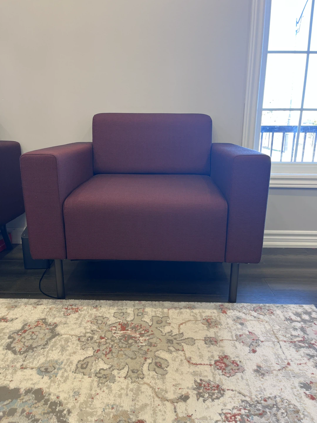 Two plum coloured armchairs