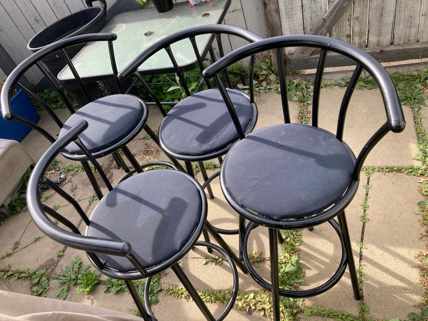 four black metal bar stools