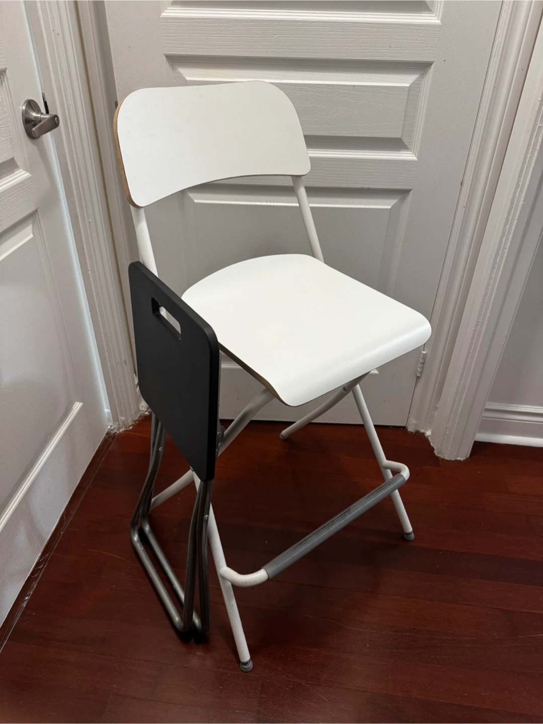 IKEA folding chair and small black stool