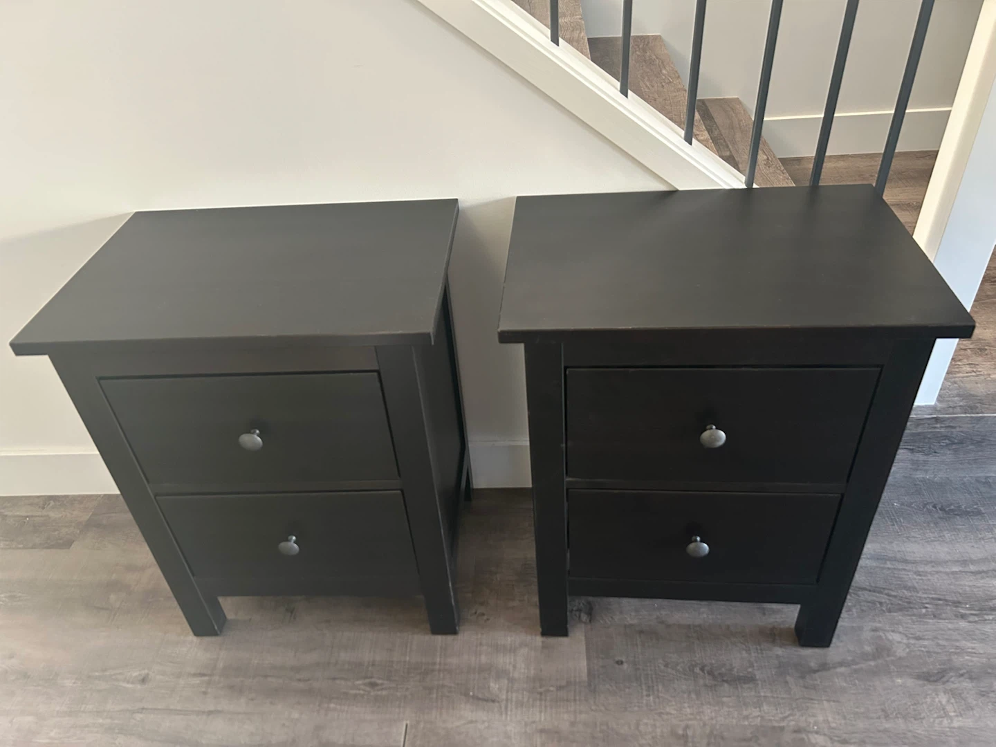 pair of IKEA nightstands in black brown