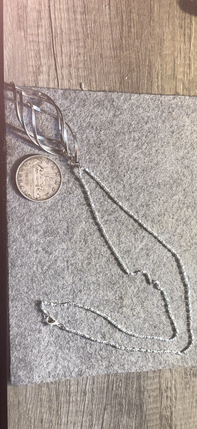 Modern style pendant and silver tone necklace