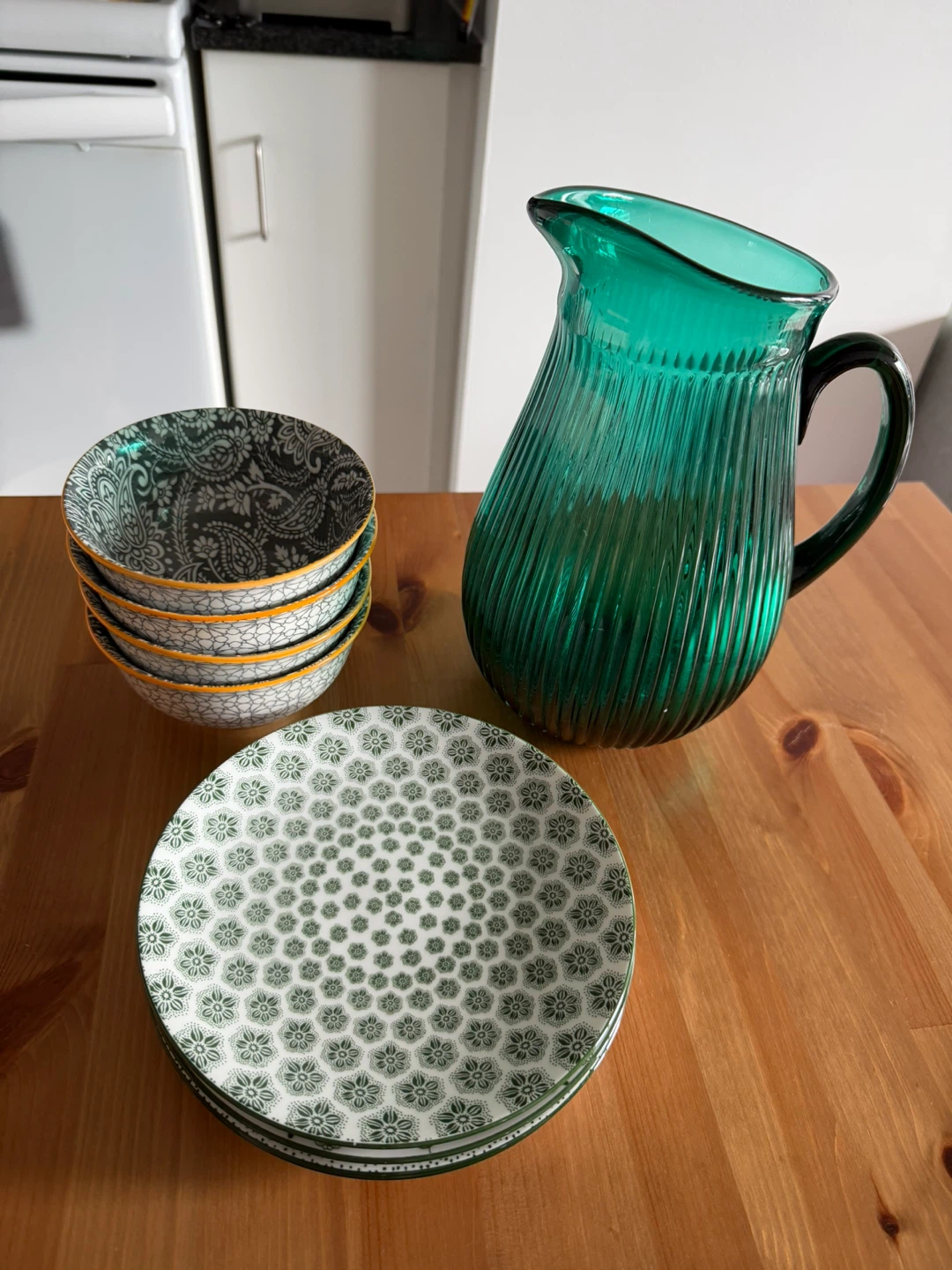 Green Glass Pitcher and Patterned Bowls and Plates Set