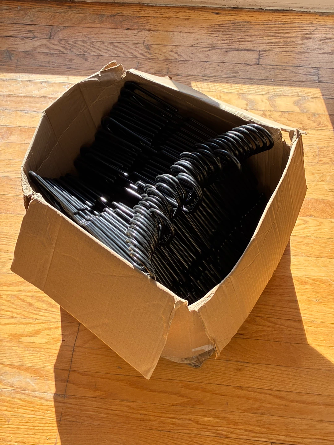 Box of Black Plastic Clothes Hangers – $10