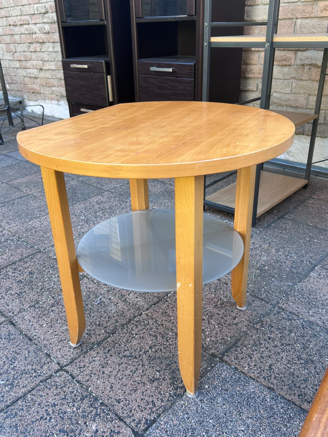 Round wooden side table with glass shelf