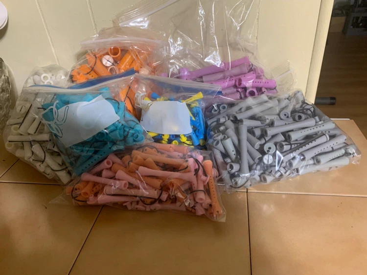 Large collection of assorted plastic perm rods