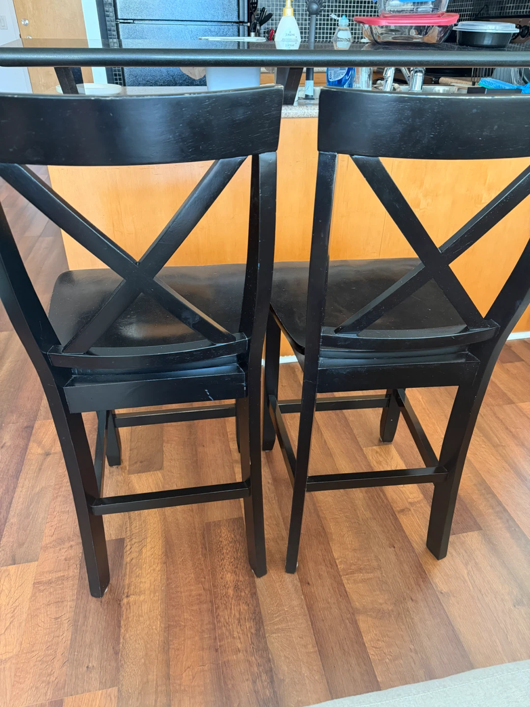Two black wood bar stools