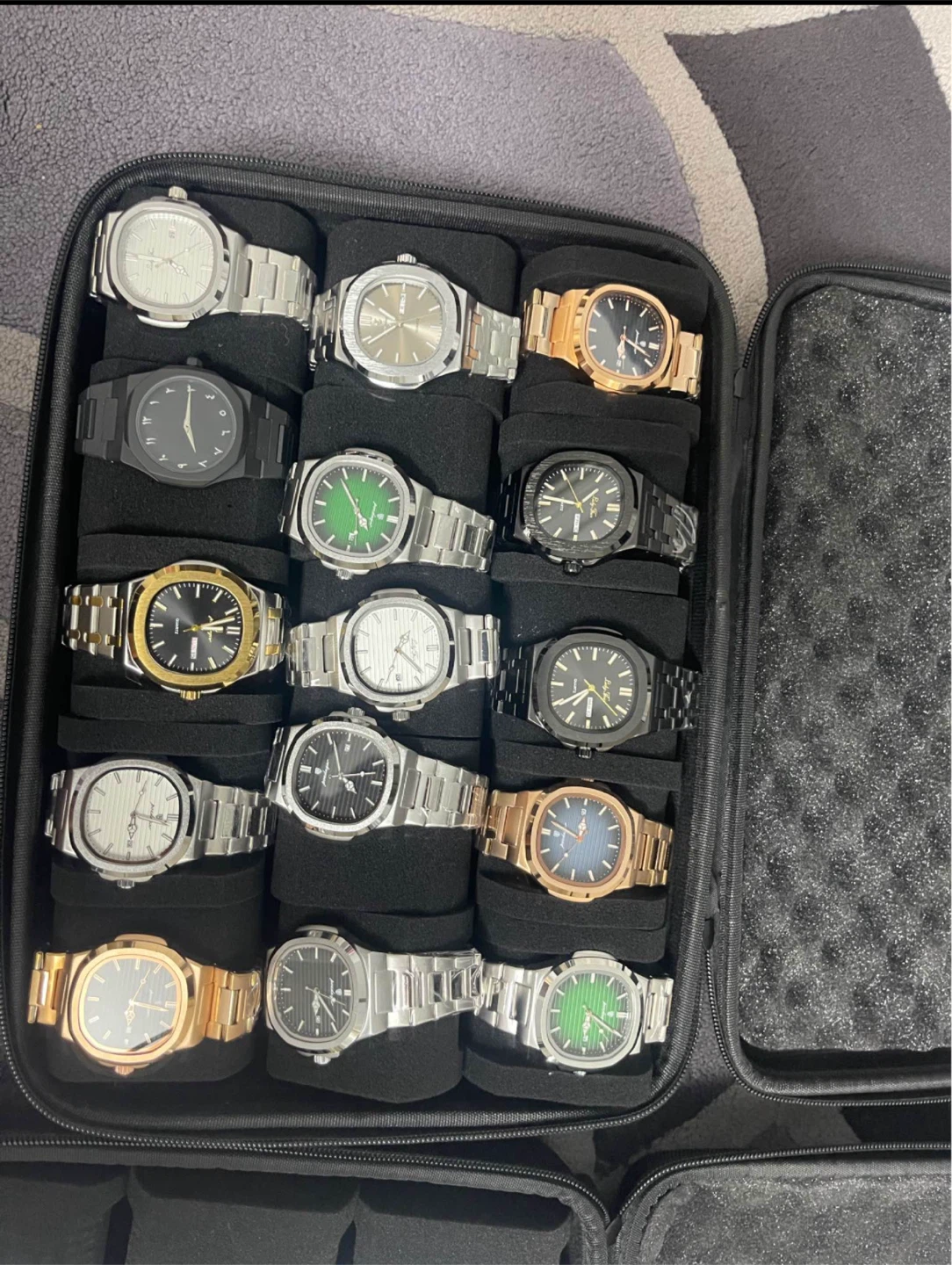 Set of 14 quartz wristwatches in storage case