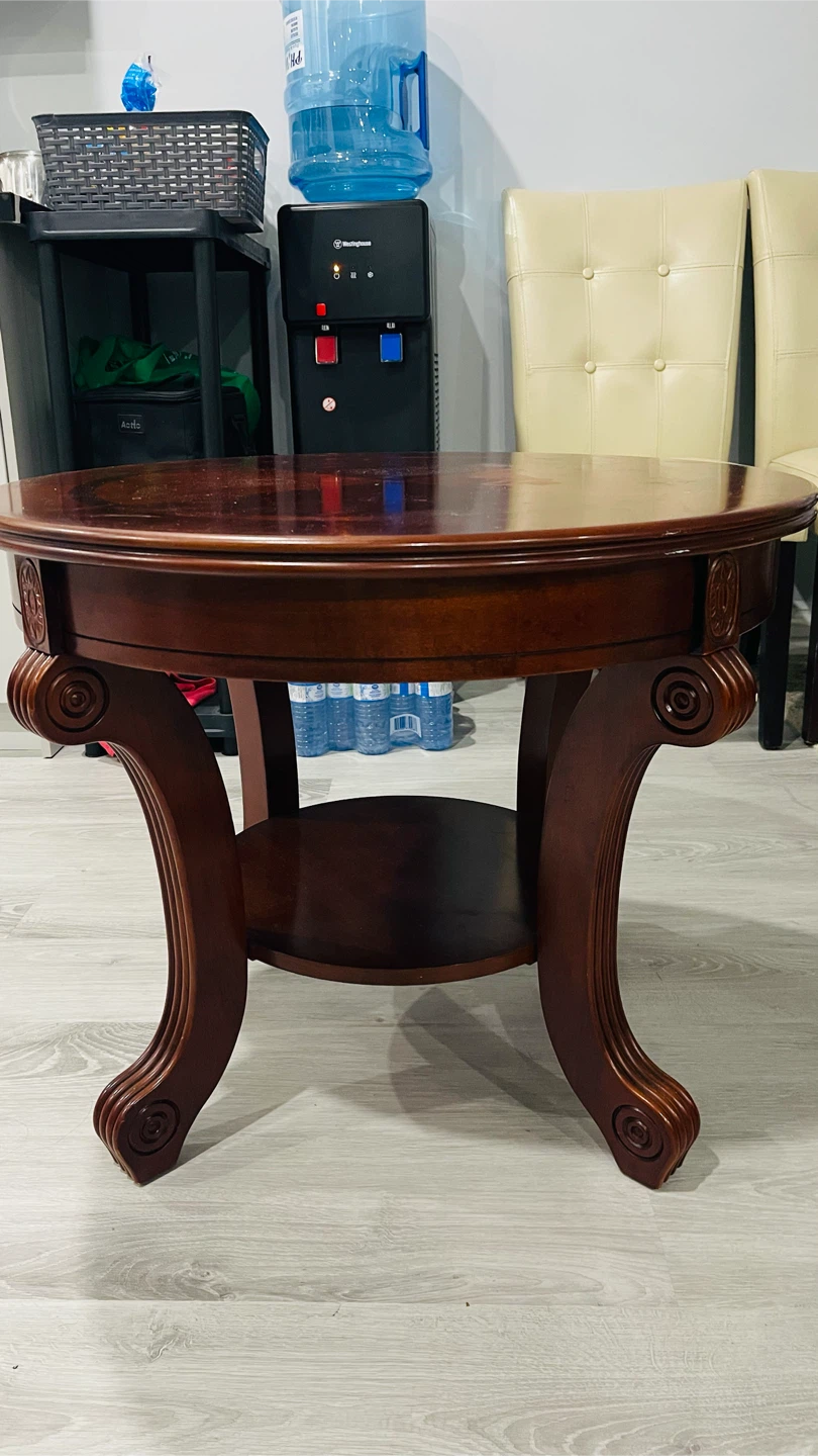 Round wooden side table and two dining chairs