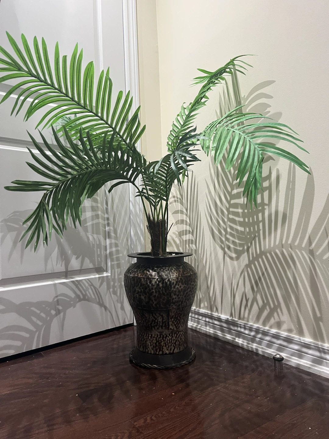 Artificial palm plant in decorative planter