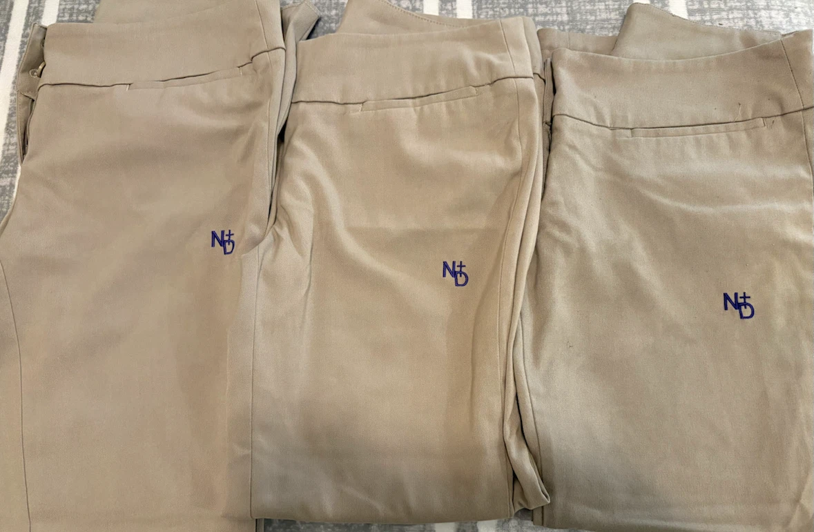 Three pairs of Notre Dame school uniform pants