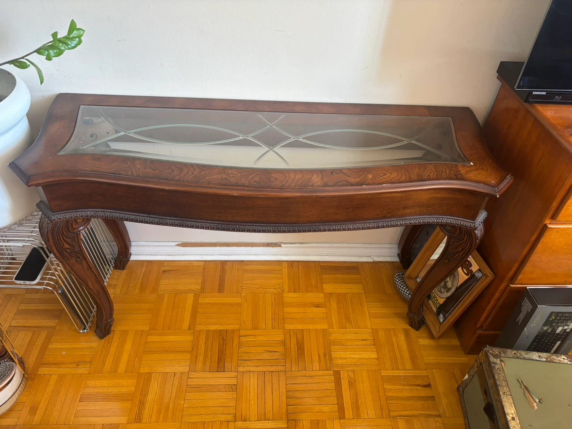Dark wood console table with glass top