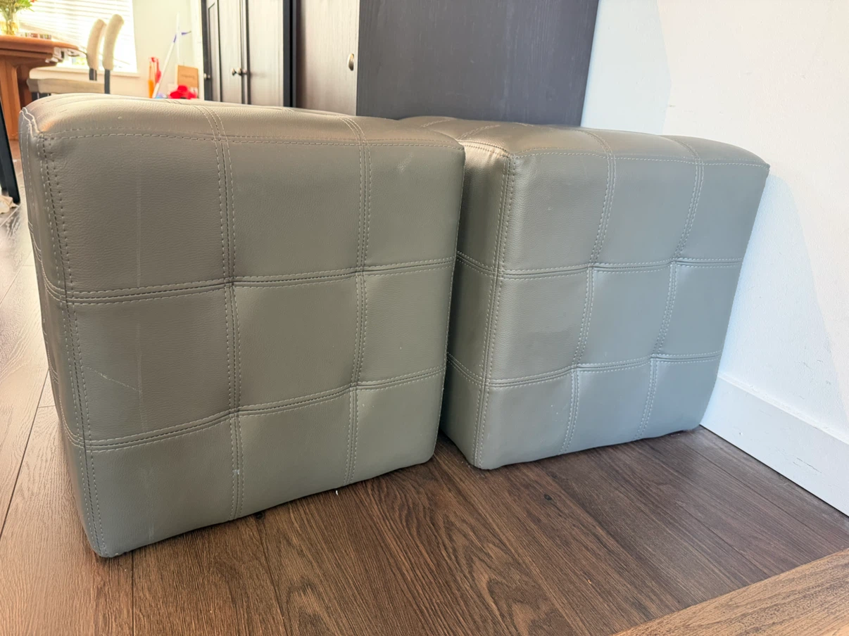 Set of two grey faux leather ottomans