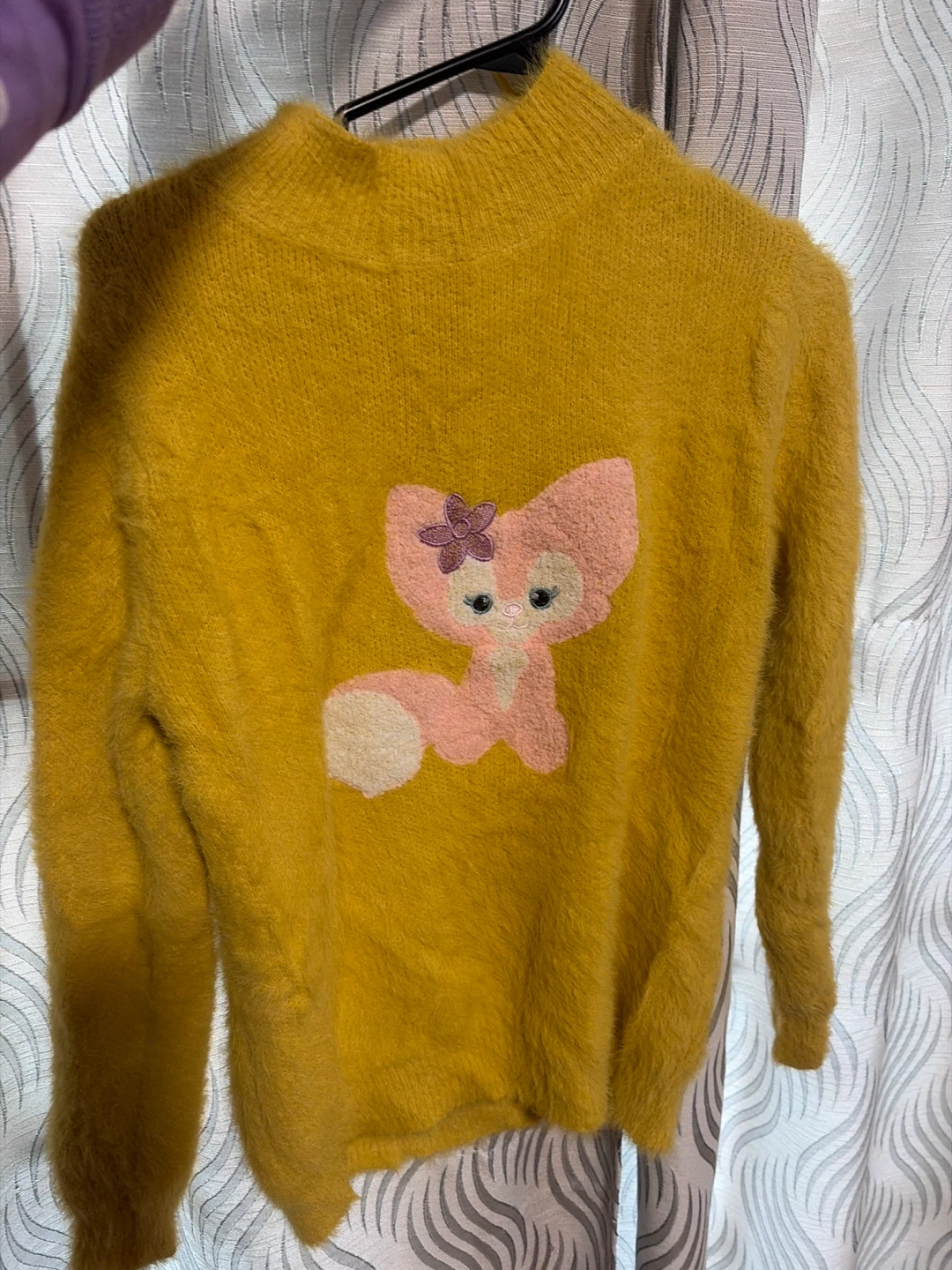 Yellow knit sweater with LinaBell character