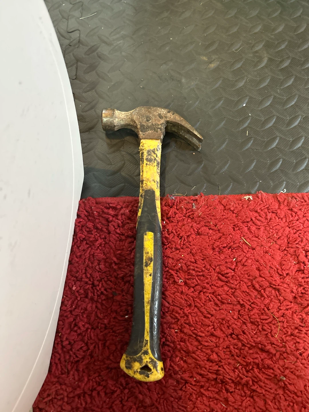 Used claw hammer with yellow and black grip